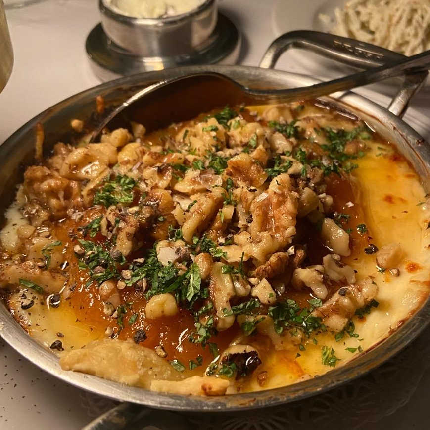 Photo of Melted Brie: apricot jam, brown butter walnuts, mint, croutons from Mon Ami Gabi