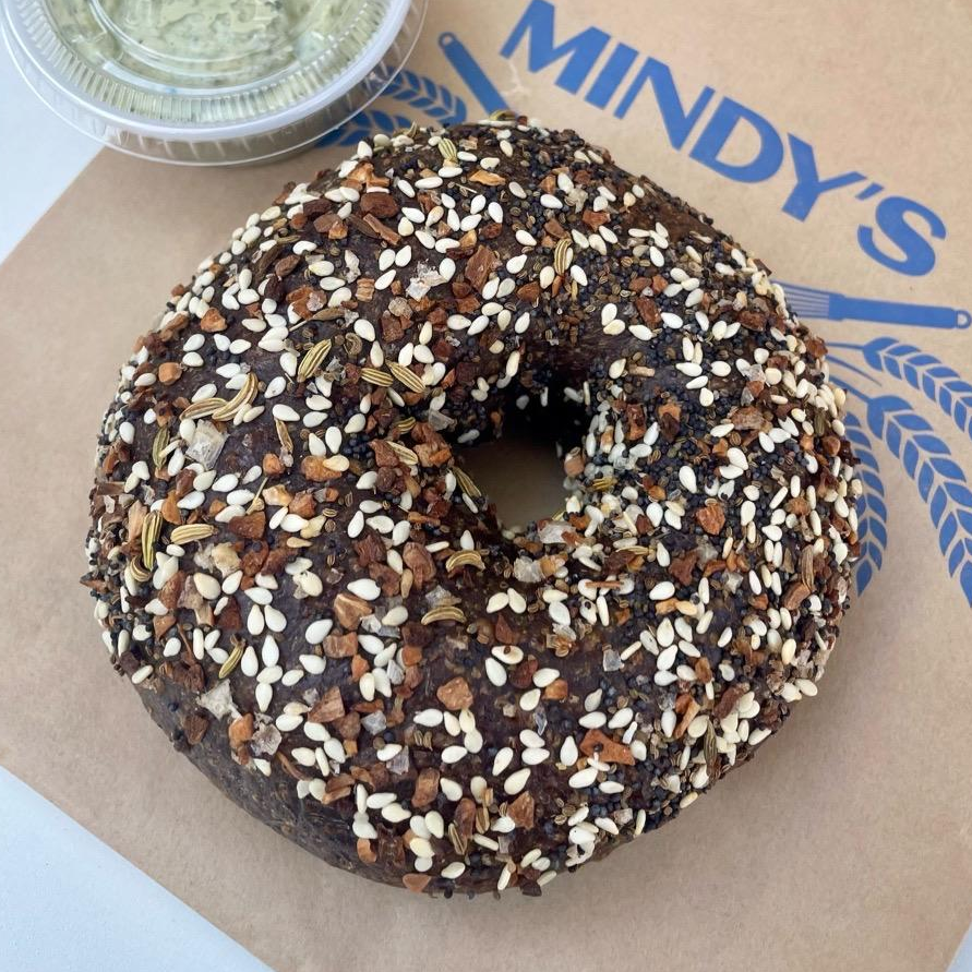 Photo of black russian bagel with chive pesto cream cheese from Mindy’s Bakery